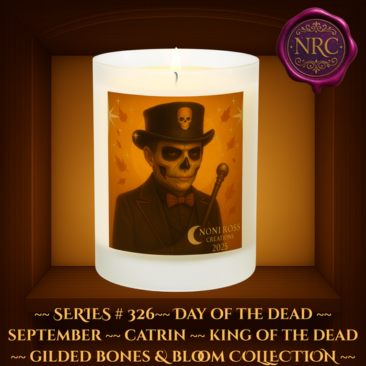 Series #326 September Day of the Dead Catrin Candle featuring skeletal face, black and bronze attire, skull cane, falling autumn leaves, and golden stars by Noni Ross Creations.