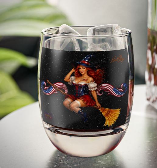 Lifestyle mockup of 6oz wine tumbler in cozy setting with celestial pinup design