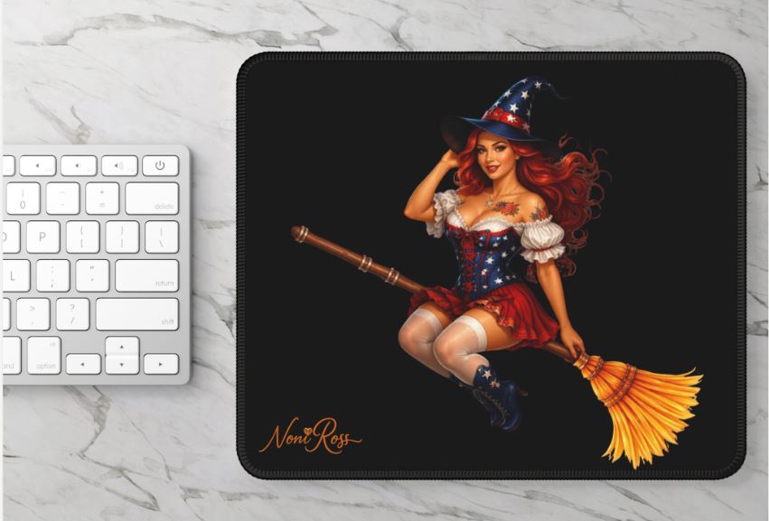 Witch mouse pad displayed on desk setup with computer showing vibrant patriotic pinup design