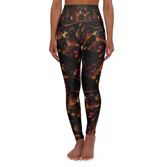 Woman wearing black high-waist yoga leggings with glowing voodoo witch artwork and gold accents